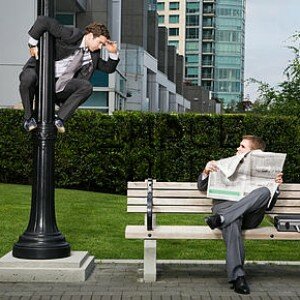 Businessman spying on colleague